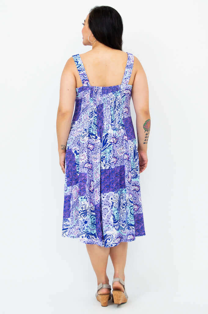 Back view of sleeveless blue and purple patchwork paisley dress with shirred bodice