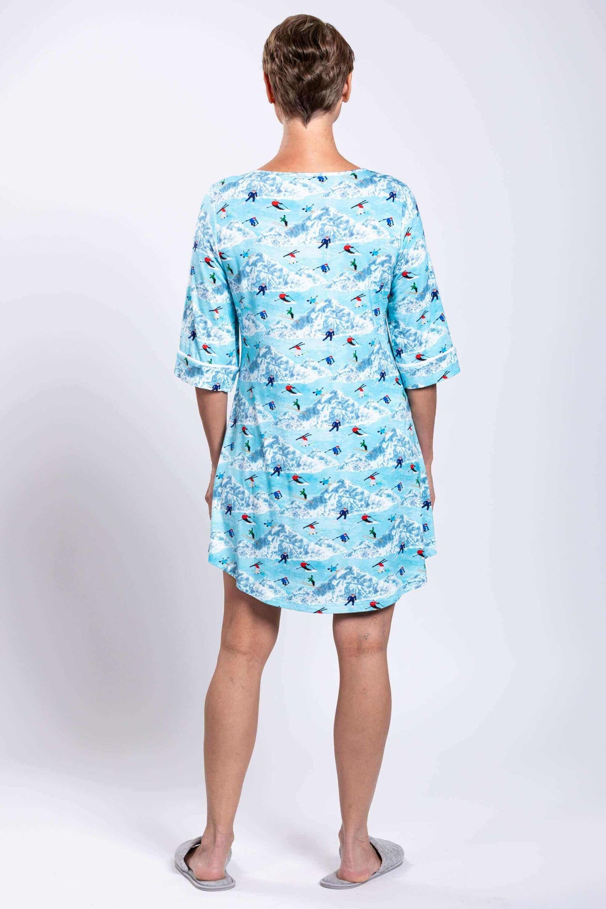 Back view of woman wearing blue bamboo sleepshirt with skiers print