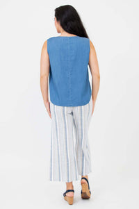 Back view of woman wearing a sleeveless blue Tencel tank top and striped pants