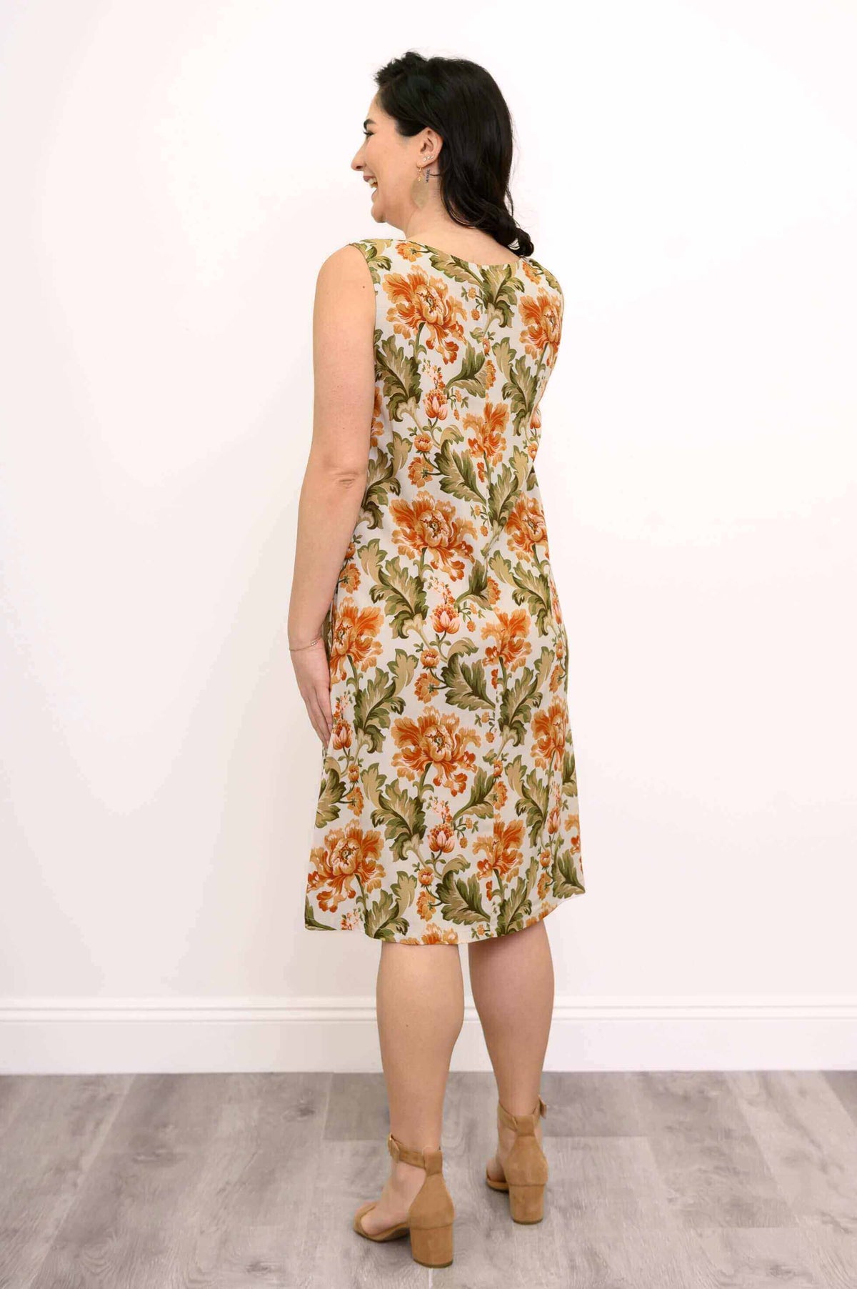 Back view of a woman in a sleeveless floral dress showing the fit and design