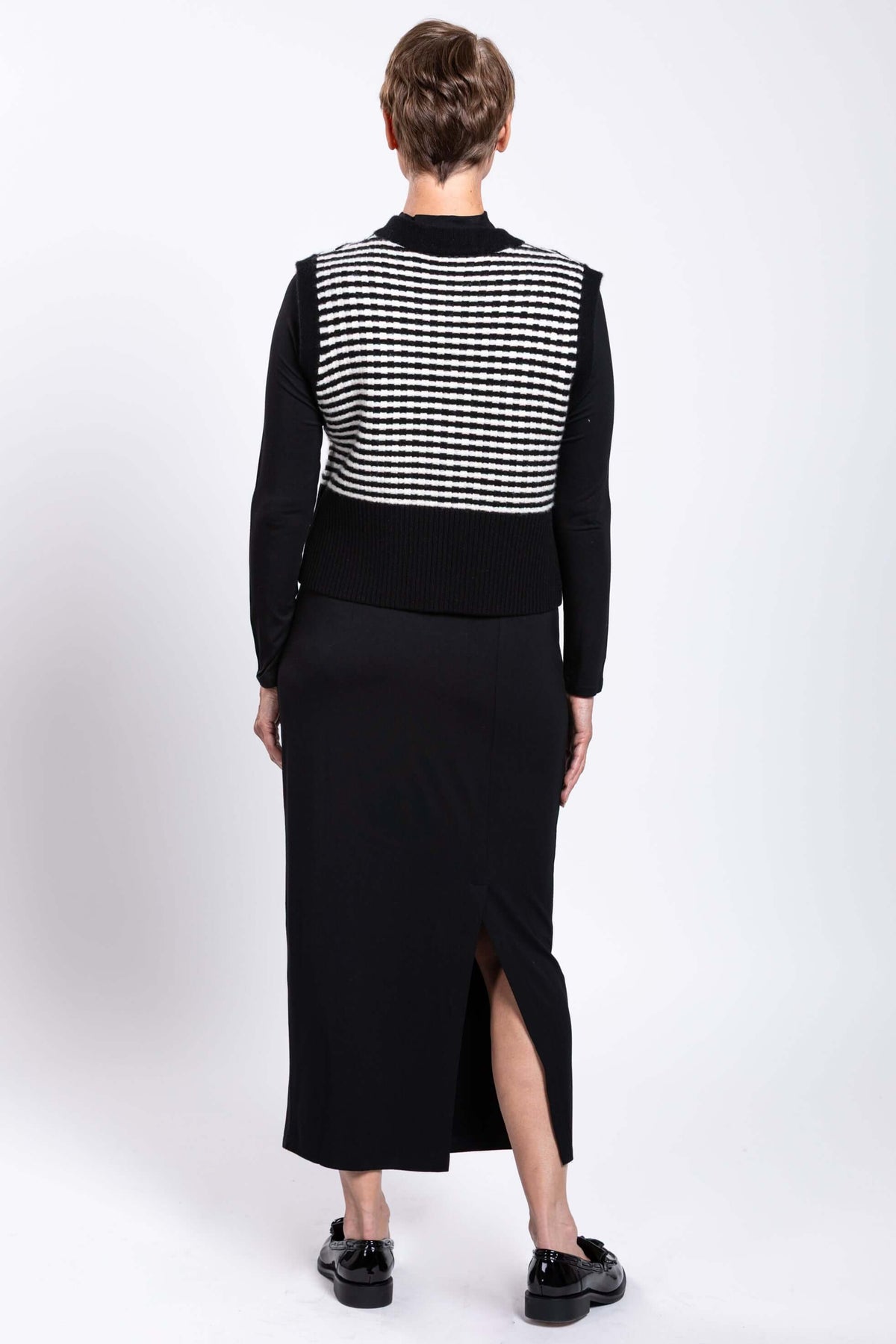 Back view of a woman showing the striped pattern of the vest