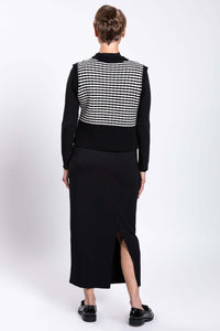 Back view of a woman showing the striped pattern of the vest