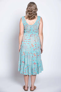 Back view of a woman wearing a light blue tiered sleeveless floral midi dress