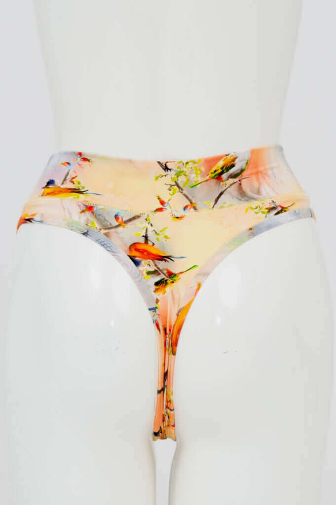 Back view of bamboo thong featuring vibrant bird and floral design