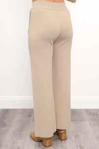Back view of beige Bailey transitional track pants highlighting smooth waistband