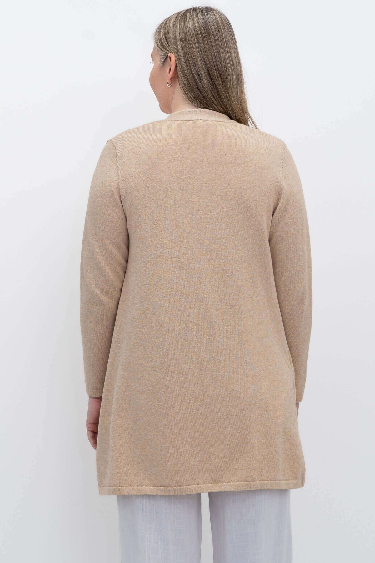 Back view of woman wearing beige Justine open cardigan sweater