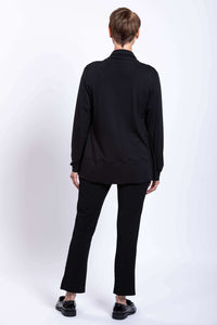 Back view of woman in black French Terry jacket, matching black pants, and black shoes