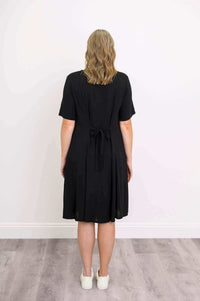 Back view of black dress showing tie-back belt detail