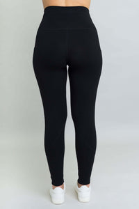 Back view of black fleece leggings showing high waistband and contoured seam details