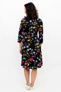 Back view of woman showing the floral wrap dress and belt detail