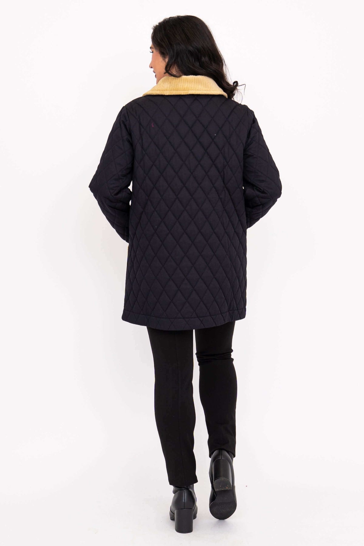 Back view of black quilted coat with tan corduroy collar