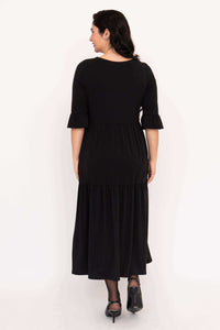 Back view of black tiered midi dress with ruffle sleeves