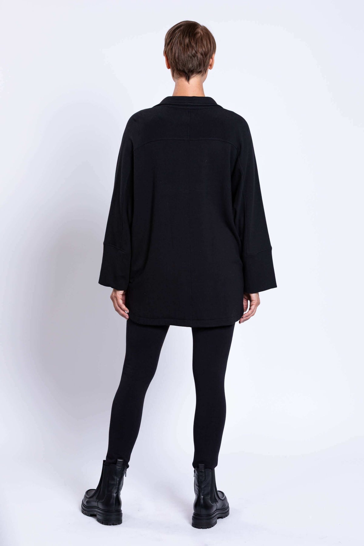 Rear view of woman in a black jacket with relaxed dolman sleeves