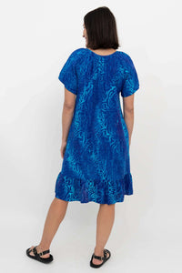 Back view of blue Samoa Dress showing ruffle hem and comfortable fit