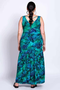Woman wearing blue and green maxi dress showing criss cross back detail