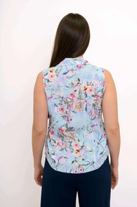 Back view of a woman wearing a blue and pink floral sleeveless shirt