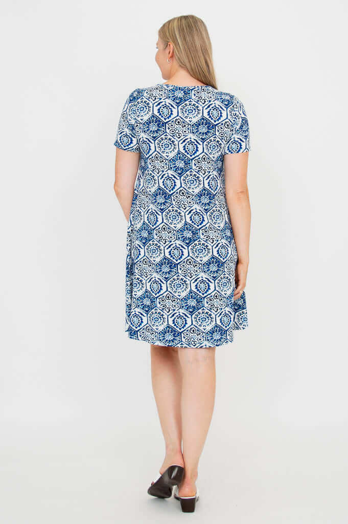 Back view of a woman modeling a blue and white patterned short-sleeve dress