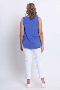 Back view of woman wearing a blue bamboo tank top and white pants