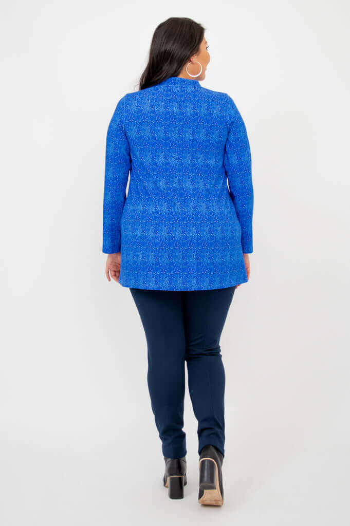 Back view of model wearing a blue bamboo tunic and navy pants with boots