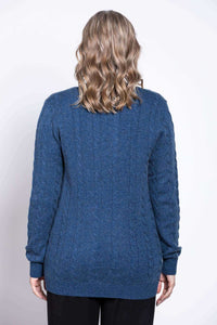 Back view of woman wearing a blue cable knit cardigan