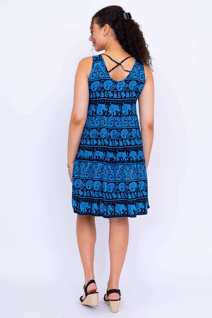 Back view of woman in blue elephant print dress showing criss-cross straps