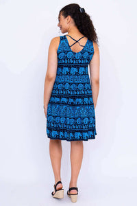 Back view of woman in blue elephant print dress showing criss-cross straps