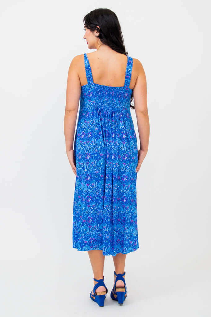 Back view showing shirred bodice of blue empire waist midi dress
