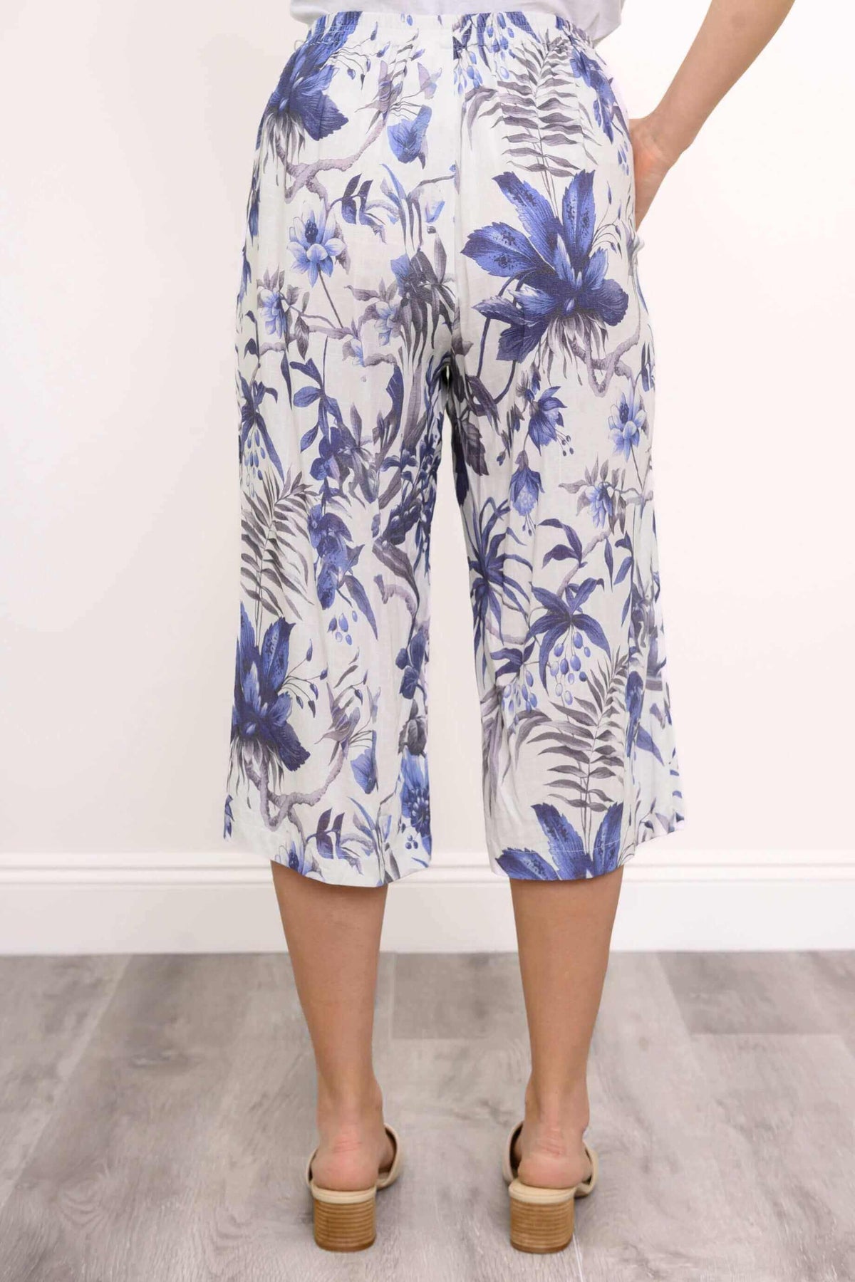 Back view of blue floral capri pants showcasing pattern and fit