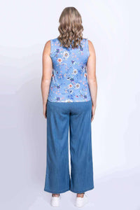 Rear view of woman wearing blue floral tank top and wide-leg pants