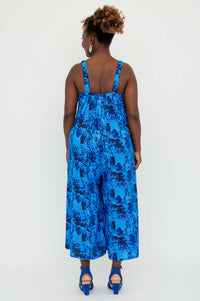 Back view of blue floral jumpsuit showcasing elastic straps