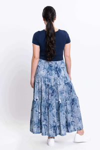 Model back view showing the blue floral skirt and navy bodice of the dress