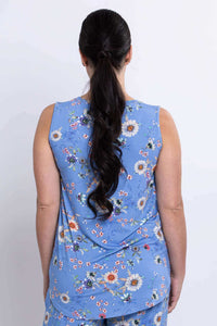 Back view of woman in blue floral sleeveless top with ponytail