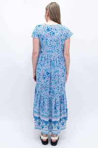 Back view of woman in blue floral tiered Sharpie Dress