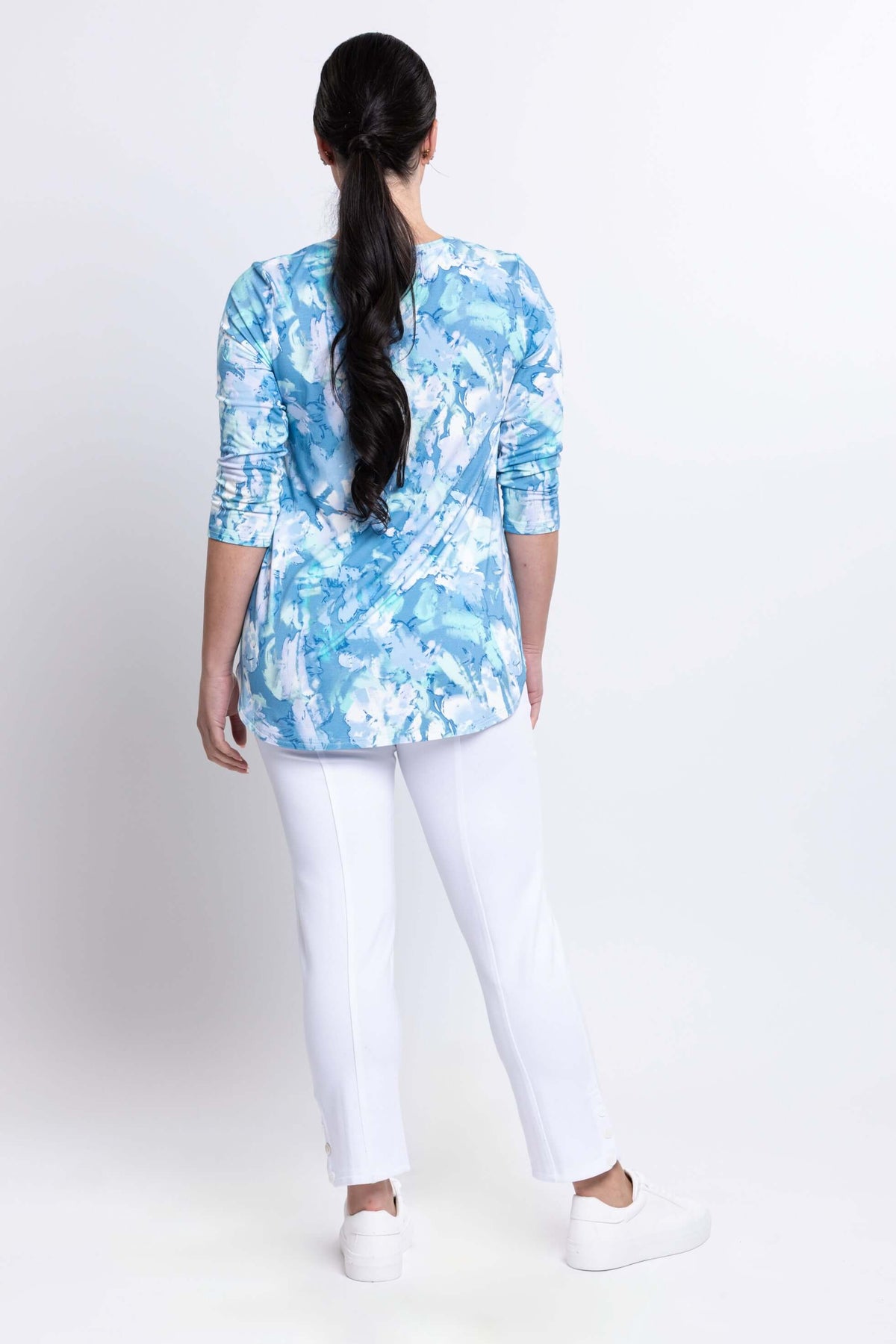 Back view of woman wearing blue haze bamboo top showing rounded hemline