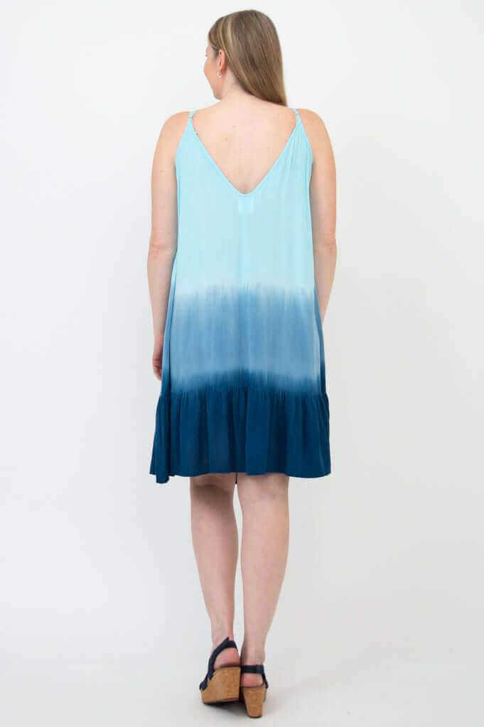 Back view of woman wearing blue ombre sleeveless dress showing v-back design