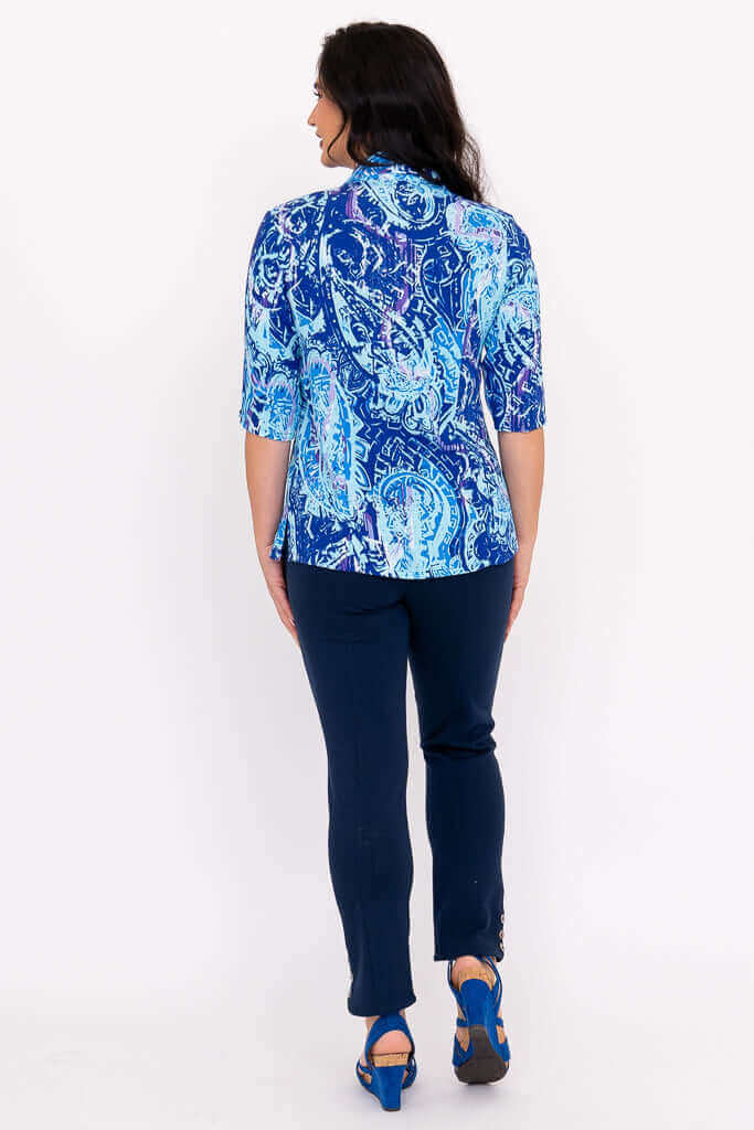 Rear view of blue mosaic print tailored blouse and navy pants outfit