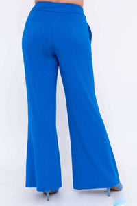Back view of blue wide-leg pants with elastic waistband and blue heels