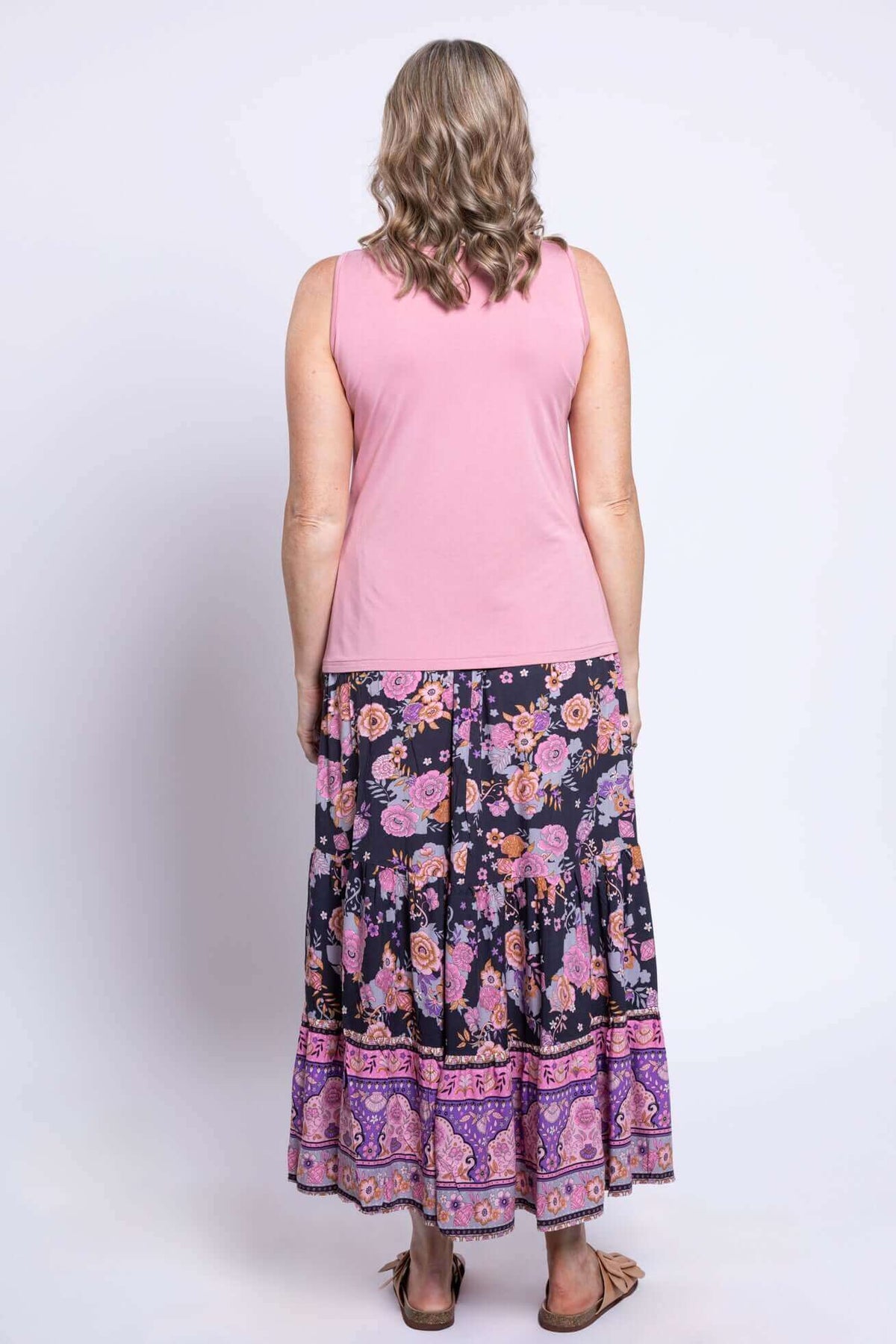 Back view of tiered floral maxi skirt and pink sleeveless top