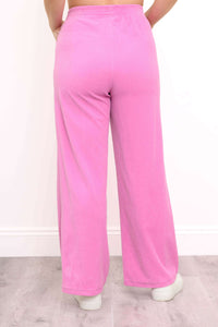 Back view of bright pink wide-leg corduroy pants showing elastic waistband