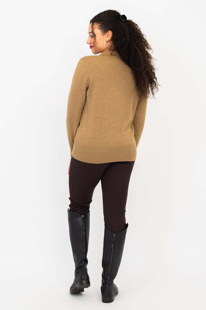 Back view of model wearing brown V-neck sweater with ribbed hem