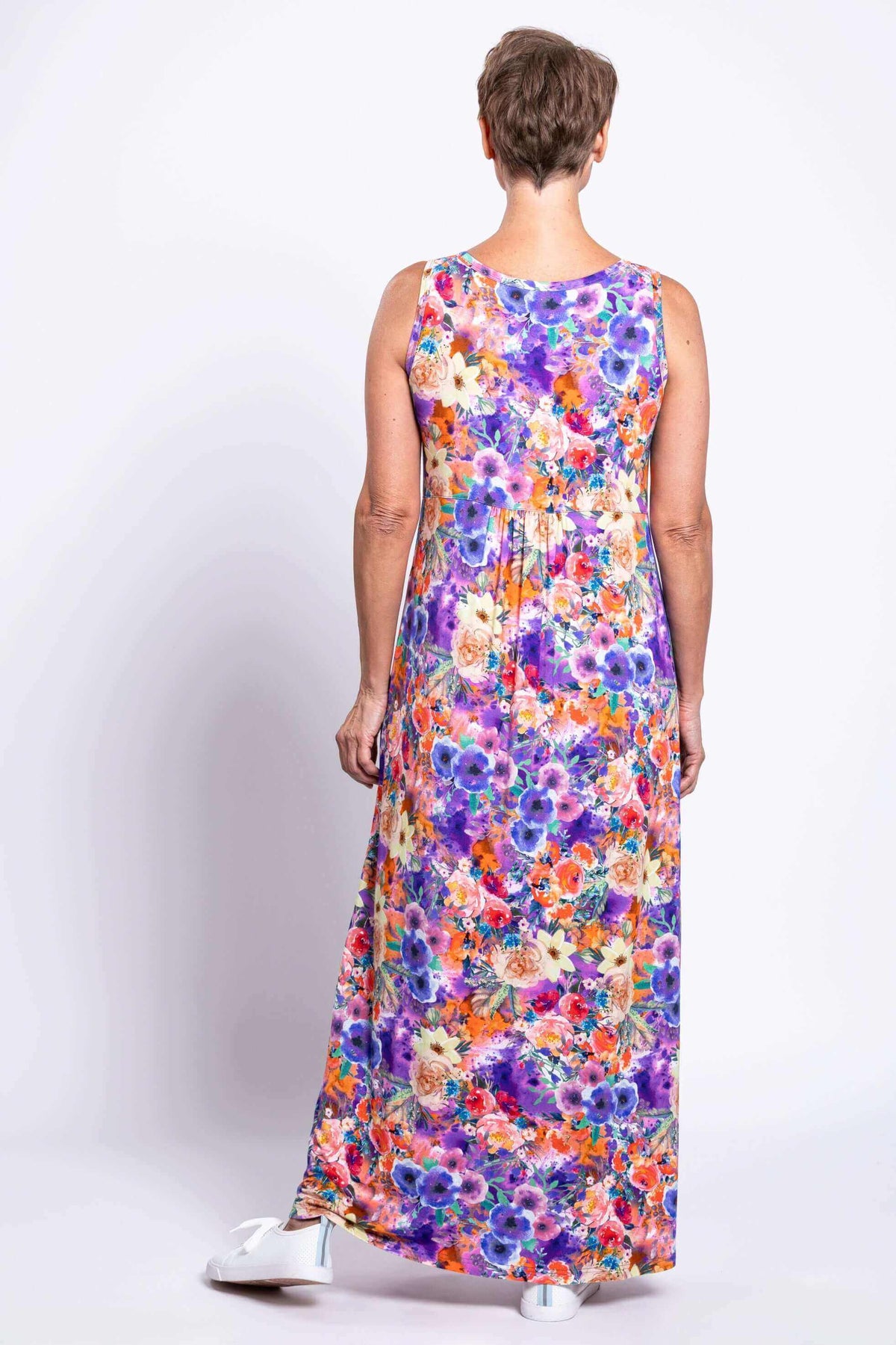 Back view of woman showing the floral print and cut of sleeveless maxi dress