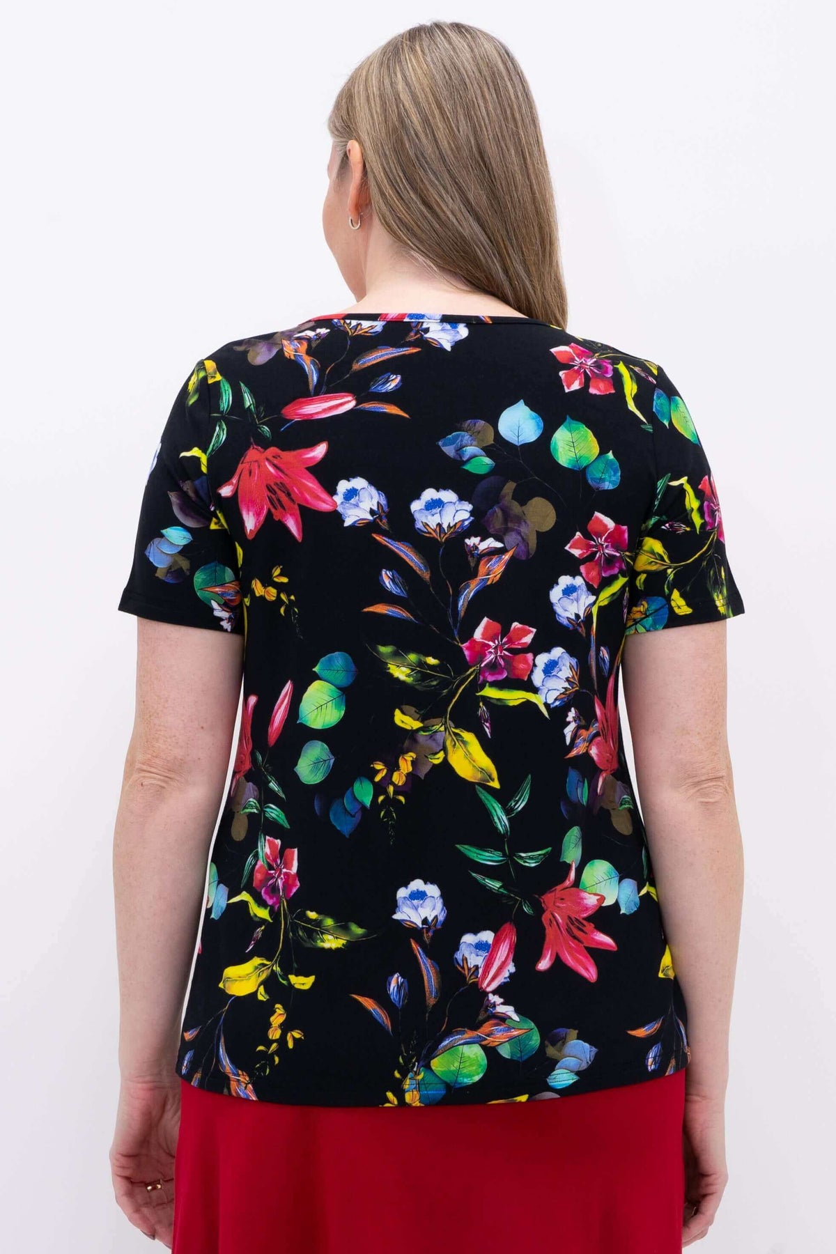 Back view of woman wearing a black bamboo top with a vibrant multicolor floral print