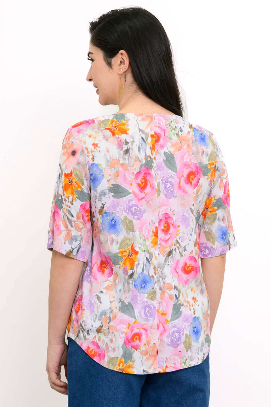 Back view of woman wearing floral elbow-sleeve blouse