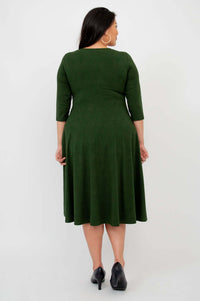 Back view of woman wearing forest green midi dress showing fit and length