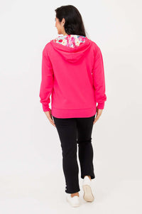Back view of woman in fuchsia hoody with floral-printed hood lining