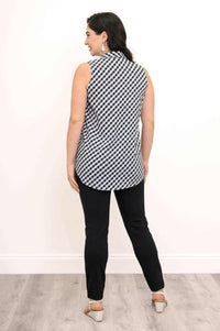 Back view of a gingham tank top on a woman wearing black pants and white sandals