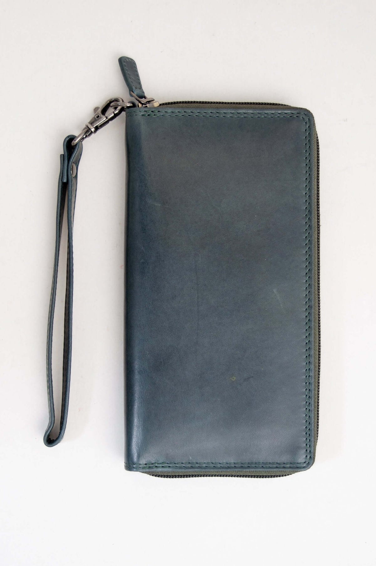Back view of handmade blue leather wallet with wrist strap
