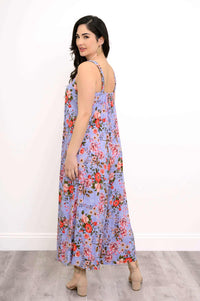 Back view of woman in a lavender floral maxi dress with red and pink flower pattern