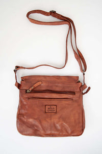 Back view of leather messenger bag with zippered pocket and logo patch
