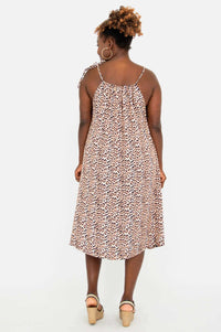 Back view of a woman in a leopard print adjustable strap dress